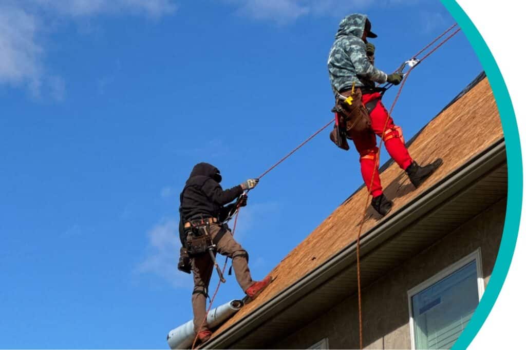 two roofers from D1 Roofing climbing on the roof of a home in Columbus, OH, to perform a roof inspection