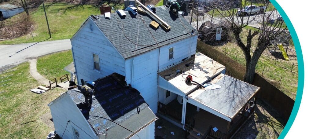 roofing experts performing shingle repair and replacement on a roof of a home in Pittsburgh, PA