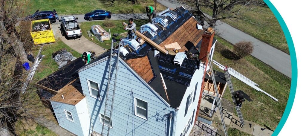 a team of roofing professionals performs storm damage roof repair on a home in Pittsburgh, PA